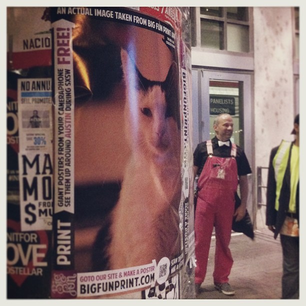 { #SXSW2013} The pink-overalls-clad gentleman had just taped on this big poster of a contemplative cat made with an app! ^ x ^ 
ビッグ・ポスターを作れるアプリ☆